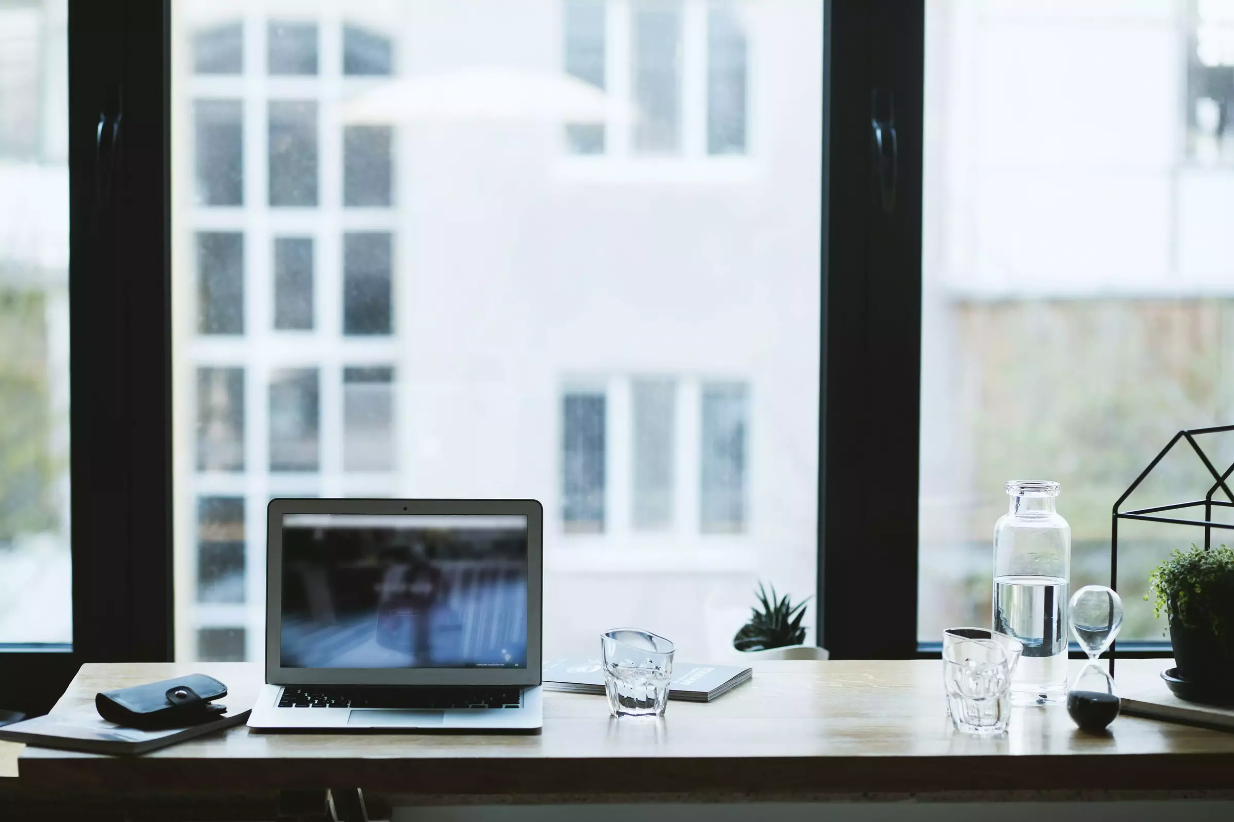 desk in home office with laptop