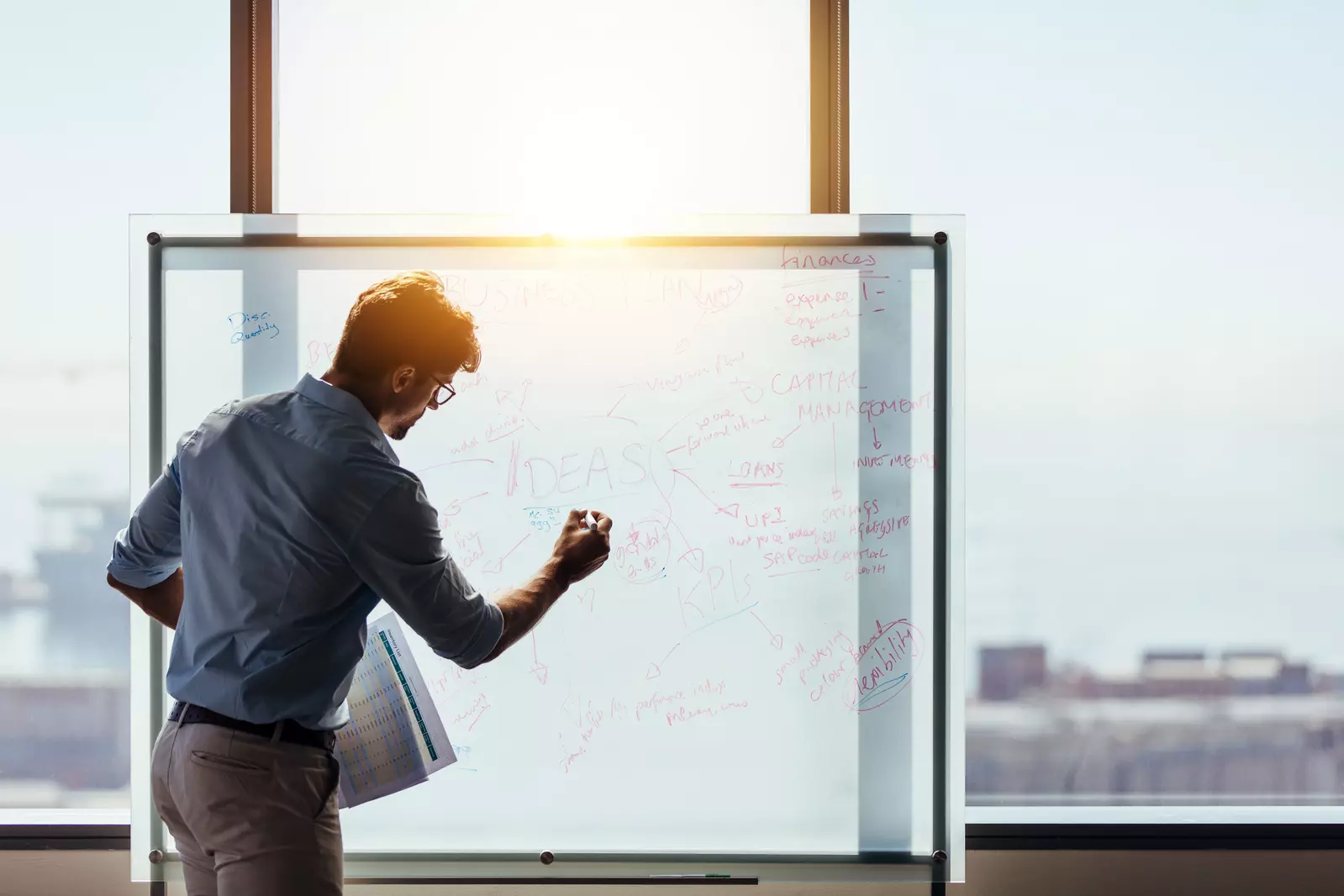 man writing on whiteboard