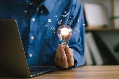 man holding a lightbulb while taking a course