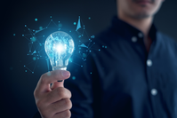 business man holding lightbulb