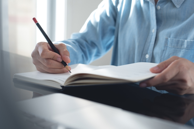 woman writing in notebook